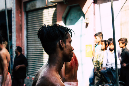 Varanasi India November 17, 2018 View of unknowns Shiite  Muslims use chains and blades during ritual self flagellation as part of the Imam Husain celebration, Ashura commemorations in the Arabian district of Varanasi in the morningのeditorial素材