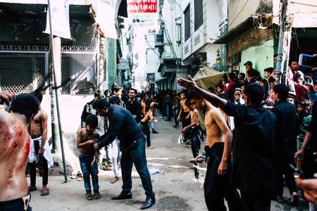 Varanasi India November 17, 2018 View of unknowns Shiite  Muslims use chains and blades during ritual self flagellation as part of the Imam Husain celebration, Ashura commemorations in the Arabian district of Varanasi in the morningのeditorial素材