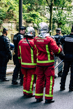 Paris France May 04, 2019 View of a French firefighters walking in the street during protests of the Yellow jackets against the policy of President Macron in Paris on saturday afternoonのeditorial素材
