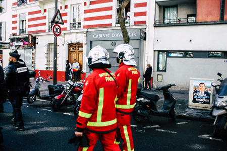 Paris France May 04, 2019 View of a French firefighters walking in the street during protests of the Yellow jackets against the policy of President Macron in Paris on saturday afternoonのeditorial素材