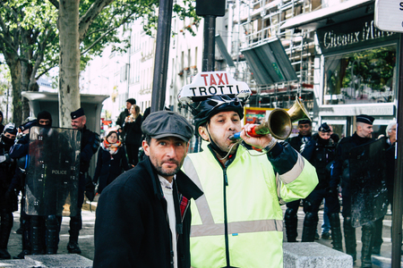 Paris France May 04, 2019 View of Yellow Jackets protesters framed by anti riot police marching against President Macron's policy in Paris on saturday afternoonのeditorial素材