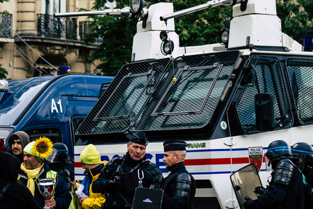 Paris France May 04, 2019 View of Yellow Jackets protesters framed by anti riot police marching against President Macron's policy in Paris on saturday afternoonのeditorial素材