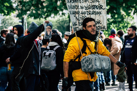 Paris France May 04, 2019 View of Yellow Jackets protesters framed by anti riot police marching...