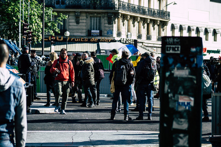 Paris France May 04, 2019 View of Yellow Jackets protesters framed by anti riot police marching...