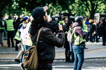 Paris France May 04, 2019 View of Yellow Jackets protesters framed by anti riot police marching against President Macron's policy in Paris on saturday afternoonのeditorial素材