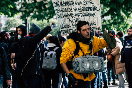 Paris France May 04, 2019 View of Yellow Jackets protesters framed by anti riot police marching against President Macron's policy in Paris on saturday afternoonのeditorial素材