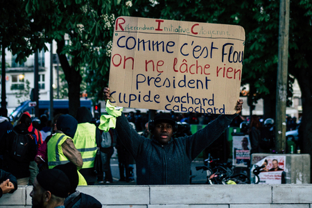 Paris France May 04, 2019 View of Yellow Jackets protesters framed by anti riot police marching...