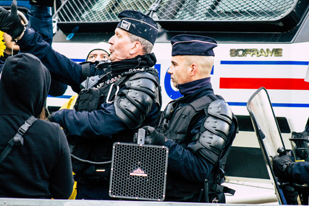 Paris France May 04, 2019 View of Yellow Jackets protesters framed by anti riot police marching...