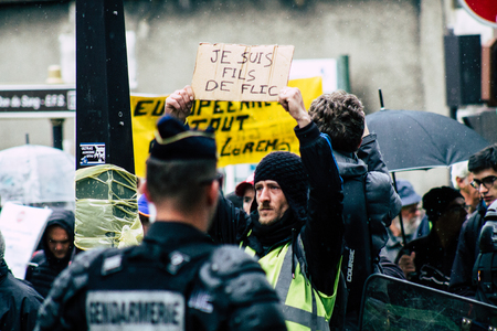 Paris France May 04, 2019 View of Yellow Jackets protesters framed by anti riot police marching against President Macron's policy in Paris on saturday afternoonのeditorial素材