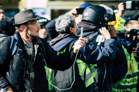 Paris France May 04, 2019 View of Yellow Jackets protesters framed by anti riot police marching against President Macron's policy in Paris on saturday afternoonのeditorial素材