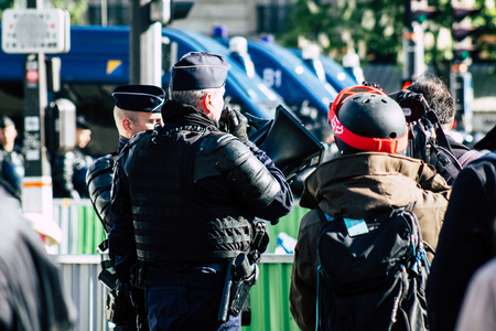 Paris France May 04, 2019 View of Yellow Jackets protesters framed by anti riot police marching against President Macron's policy in Paris on saturday afternoonのeditorial素材