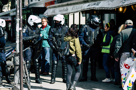 Paris France May 04, 2019 View of Yellow Jackets protesters framed by anti riot police marching...