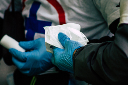 Paris France May 04, 2019 View of French street medic helping a protester injured by the riot squad of the French National Police in the street during protests of the Yellow jackets against the policy of President Macron in Paris on saturday afternoonのeditorial素材