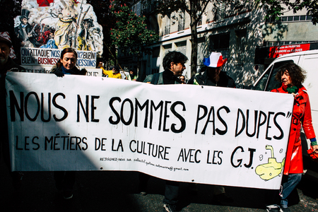 Paris France May 04, 2019 View of Yellow Jackets protesters framed by anti riot police marching...