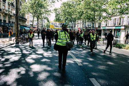 Paris France May 04, 2019 View of Yellow Jackets protesters framed by anti riot police marching against President Macron's policy in Paris on saturday afternoonのeditorial素材