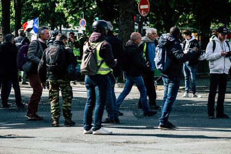 Paris France May 04, 2019 View of Yellow Jackets protesters framed by anti riot police marching...