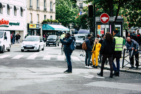 Paris France May 04, 2019 View of Yellow Jackets protesters framed by anti riot police marching...