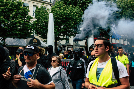 Reims France May 18, 2019 View of unknown rioters walking in the streets of Reims during the protests of the Yellow Jackets against the policy of President Macron on Saturday afternoonのeditorial素材