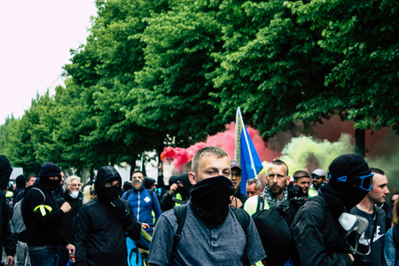 Reims France May 18, 2019 View of unknown rioters walking in the streets of Reims during the protests of the Yellow Jackets against the policy of President Macron on Saturday afternoonのeditorial素材