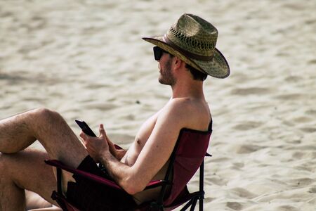 Portrait of unknown Israeli people having fun on the beach of Tel Aviv in the afternoonの写真素材