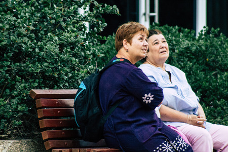 Tel Aviv Israel June 10, 2019 View of unknown Israeli people sitting on a public bench in the streets of Tel Aviv in the afternoonのeditorial素材