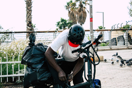 Tel Aviv Israel June 10, 2019 View of unknown Israeli people rolling with a bicycle in the streets of Tel Aviv in the afternoonのeditorial素材