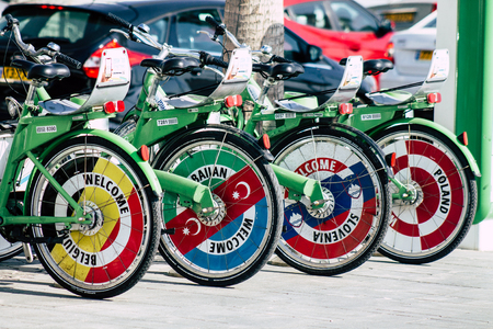 Tel Aviv Israel June 10, 2019 View of green electric bicycles to hire parked front the beach of Tel Aviv in the afternoonのeditorial素材