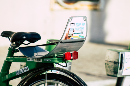 Tel Aviv Israel June 10, 2019 View of green electric bicycles to hire parked front the beach of Tel Aviv in the afternoonのeditorial素材