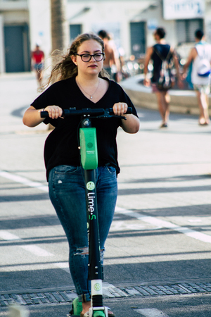 Tel Aviv Israel June 10, 2019 View of unknown Israeli people rolling with a electric scooter in the streets of Tel Aviv in the afternoonのeditorial素材