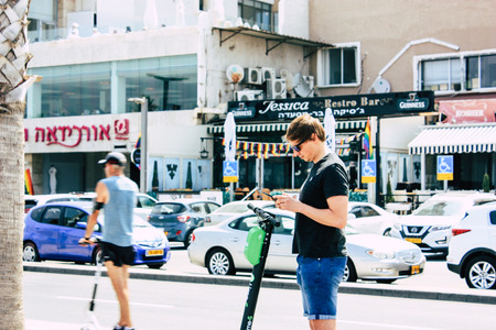 Tel Aviv Israel June 10, 2019 View of unknown Israeli people rolling with a electric scooter in the streets of Tel Aviv in the afternoonのeditorial素材