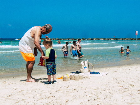 Tel Aviv Israel June 9, 2019 View of unknown Israeli children having fun on the beach of Tel Aviv in the afternoonのeditorial素材