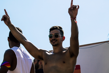 Tel Aviv Israel June 14, 2019 View of unknown Israeli people watching the gay pride parade of Tel Aviv from the balcony in the afternoonのeditorial素材
