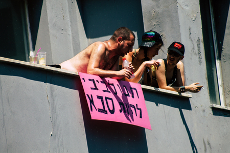 Tel Aviv Israel June 14, 2019 View of unknown Israeli people watching the gay pride parade of Tel Aviv from the balcony in the afternoonのeditorial素材