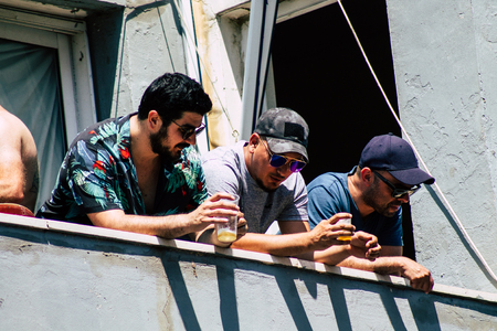 Tel Aviv Israel June 14, 2019 View of unknown Israeli people watching the gay pride parade of Tel Aviv from the balcony in the afternoonのeditorial素材