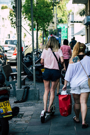 Tel Aviv Israel June 15, 2019 View of unknown Israeli people rolling with a electric scooter in the streets of Tel Aviv in the afternoonのeditorial素材