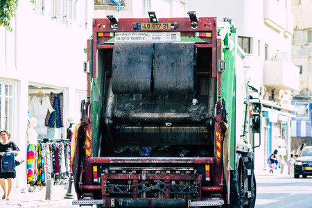 Tel Aviv Israel June 14, 2019 View of a green garbage truck rolling in the streets of Tel Aviv in the afternoonのeditorial素材