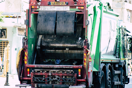 Tel Aviv Israel June 14, 2019 View of a green garbage truck rolling in the streets of Tel Aviv in the afternoonのeditorial素材