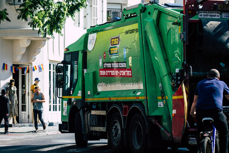 Tel Aviv Israel June 14, 2019 View of a green garbage truck rolling in the streets of Tel Aviv in...