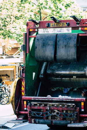Tel Aviv Israel June 14, 2019 View of a green garbage truck rolling in the streets of Tel Aviv in the afternoonのeditorial素材