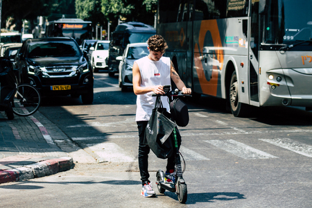 Tel Aviv Israel June 15, 2019 View of unknown Israeli people rolling with a electric scooter in the streets of Tel Aviv in the afternoonのeditorial素材