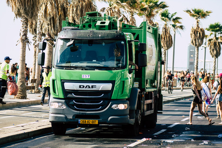 Tel Aviv Israel June 14, 2019 View of a green garbage truck rolling in the streets of Tel Aviv in the afternoonのeditorial素材