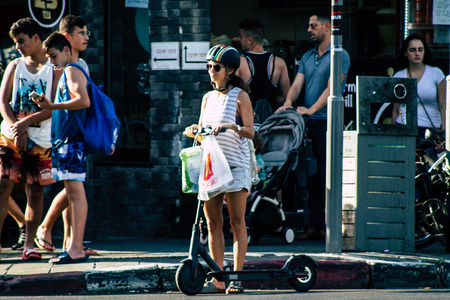 Tel Aviv Israel June 17, 2019 View of unknown Israeli people rolling with a electric scooter in the streets of Tel Aviv in the afternoonのeditorial素材
