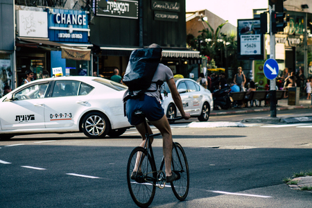 Tel Aviv Israel June 16, 2019 View of unknown Israeli people rolling with a bicycle in the streets of Tel Aviv in the afternoonのeditorial素材