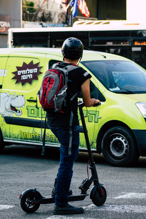Tel Aviv Israel June 17, 2019 View of unknown Israeli people rolling with a electric scooter in the streets of Tel Aviv in the afternoonのeditorial素材