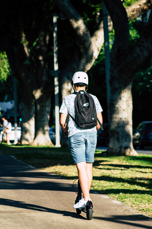 Tel Aviv Israel June 17, 2019 View of unknown Israeli people rolling with a electric scooter in the streets of Tel Aviv in the afternoonのeditorial素材