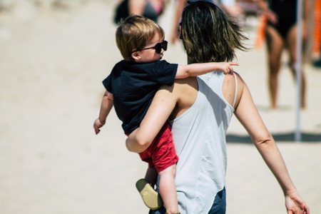 Tel Aviv Israel June 8, 2019 View of unknown Israeli children and parent having fun on the beach of Tel Aviv in the afternoonのeditorial素材