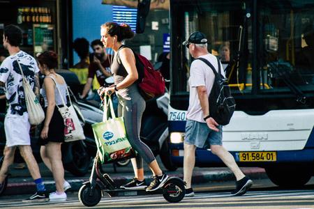 Tel Aviv Israel June 17, 2019 View of unknown Israeli people rolling with a electric scooter in the streets of Tel Aviv in the afternoonのeditorial素材