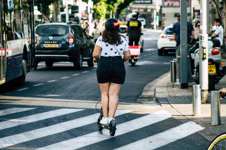 Tel Aviv Israel June 17, 2019 View of unknown Israeli people rolling with a electric scooter in the streets of Tel Aviv in the afternoonのeditorial素材