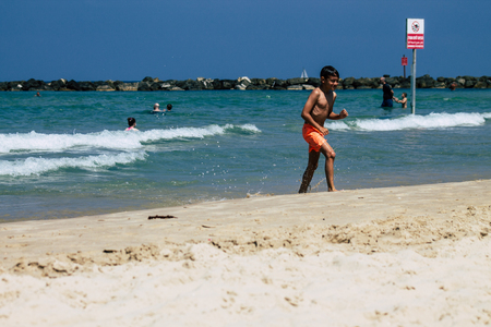 Tel Aviv Israel June 15, 2019 View of unknown Israeli children having fun on the beach of Tel Aviv in the afternoonのeditorial素材
