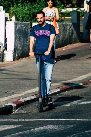 Tel Aviv Israel June 17, 2019 View of unknown Israeli people rolling with a electric scooter in the streets of Tel Aviv in the afternoonのeditorial素材